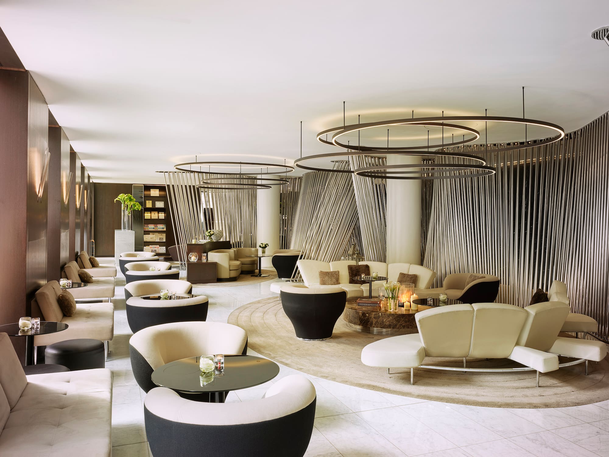 a room with a large round table and chairs