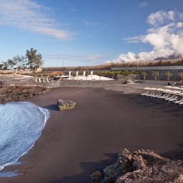 a beach with chairs and rocks
