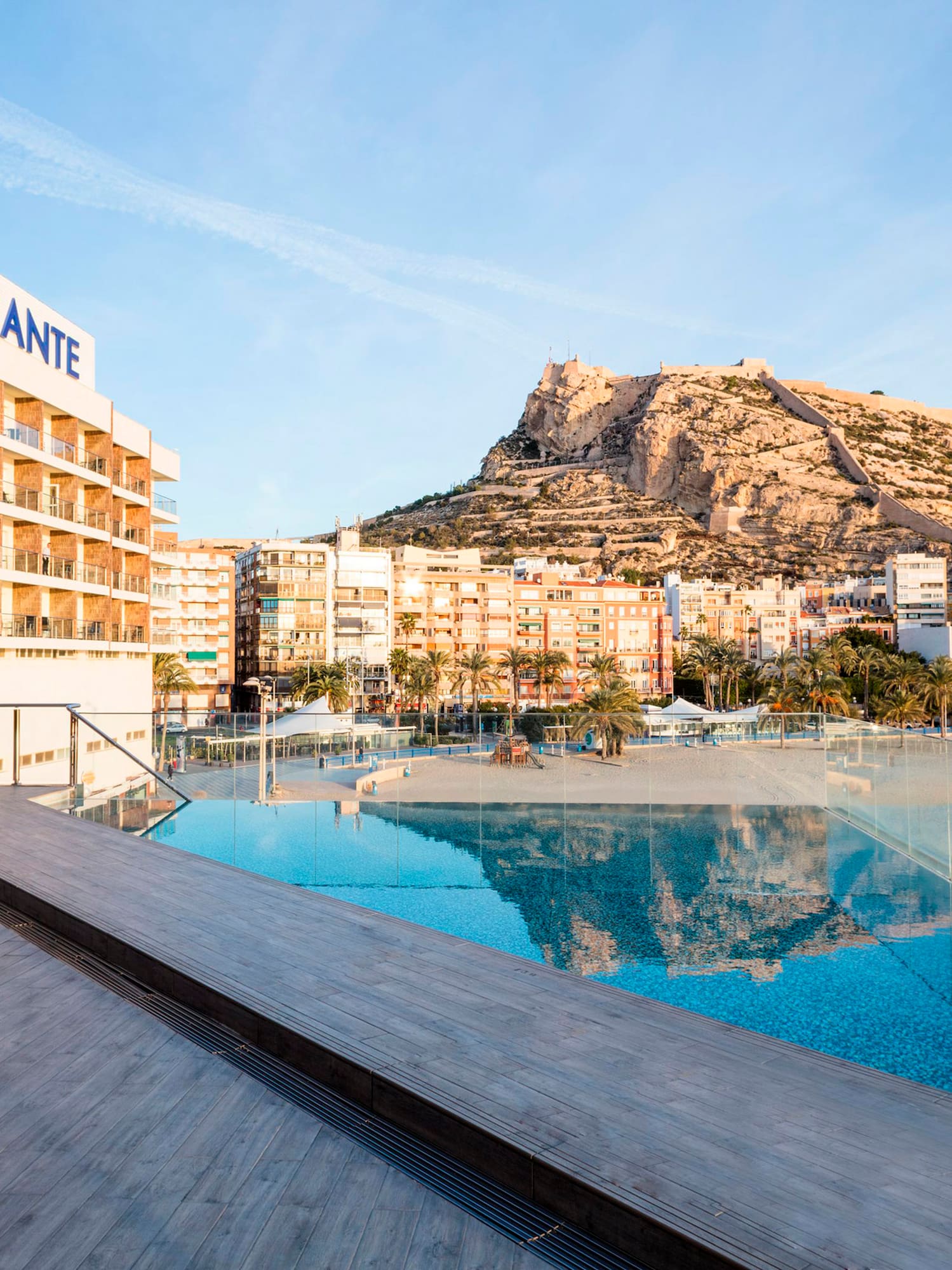 a pool with a large building in the background