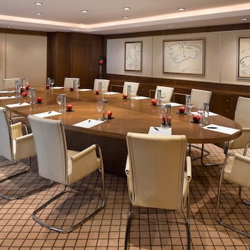 a conference room with a round table and chairs