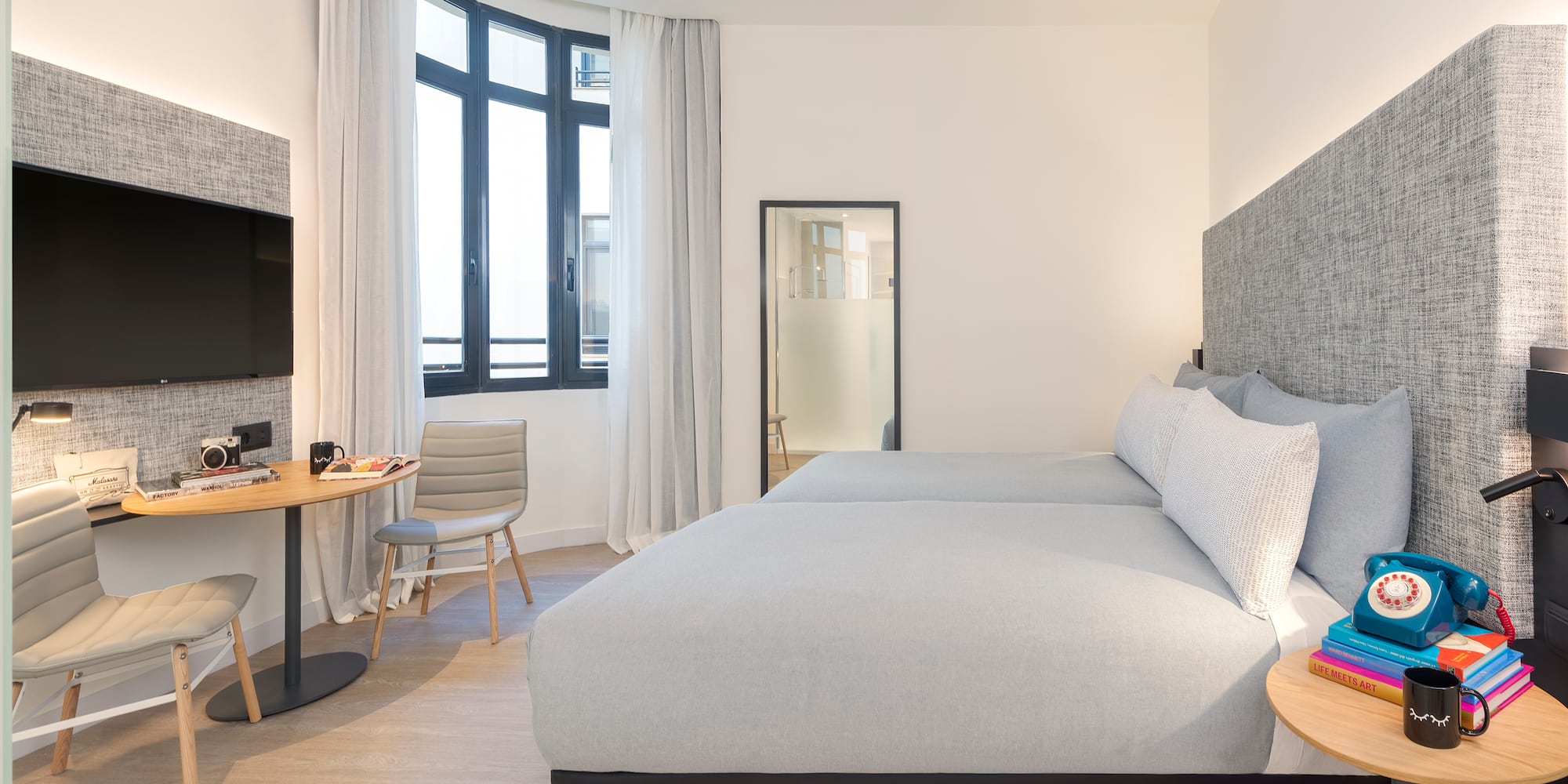 a bedroom with a bed and a table