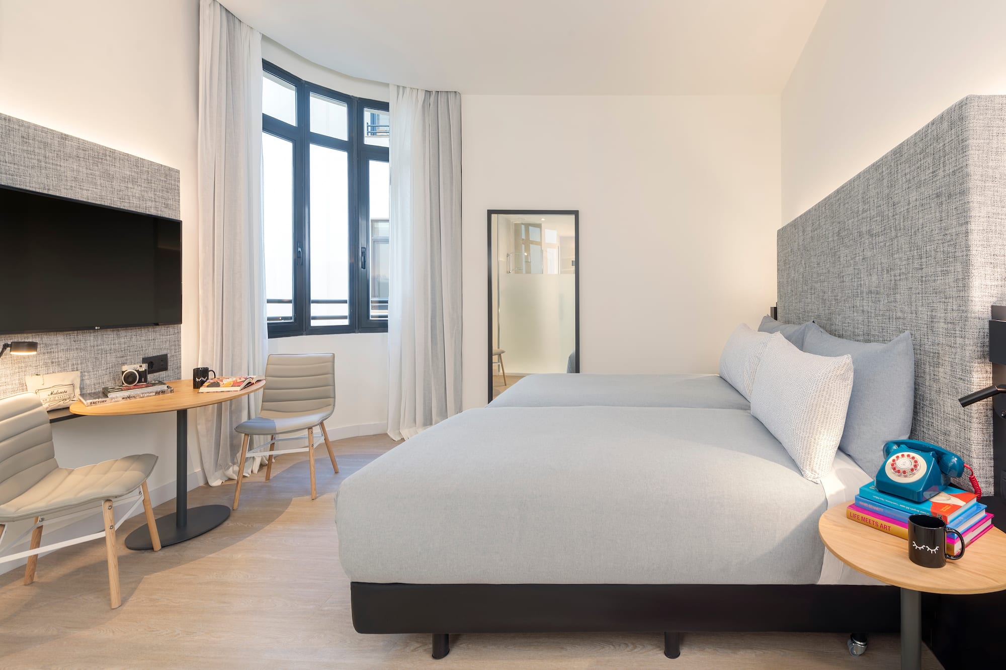 a bedroom with a bed and a table