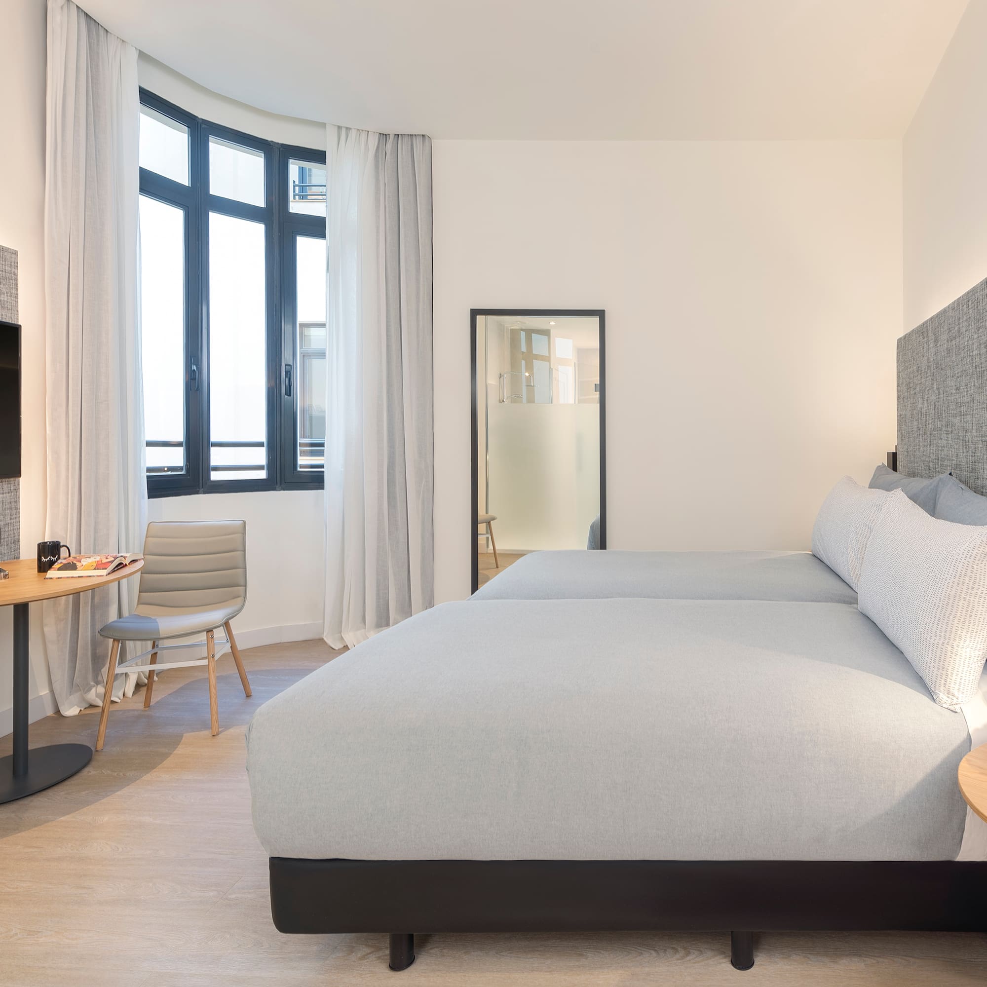 a bedroom with a bed and a table