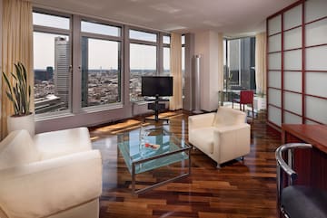 a living room with a television and a glass table