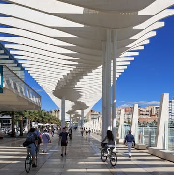 a group of people walking on a walkway