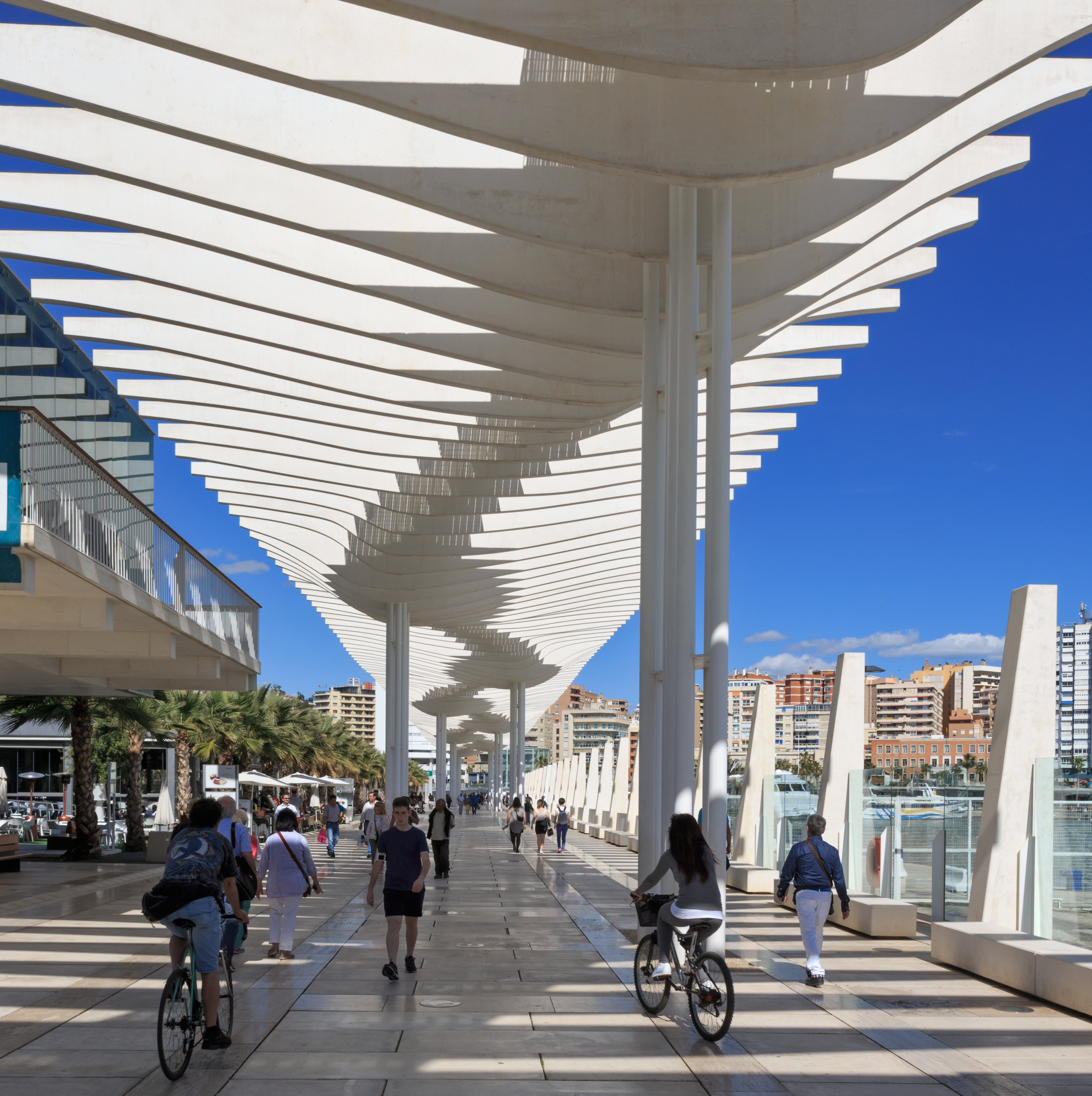 a group of people walking on a walkway
