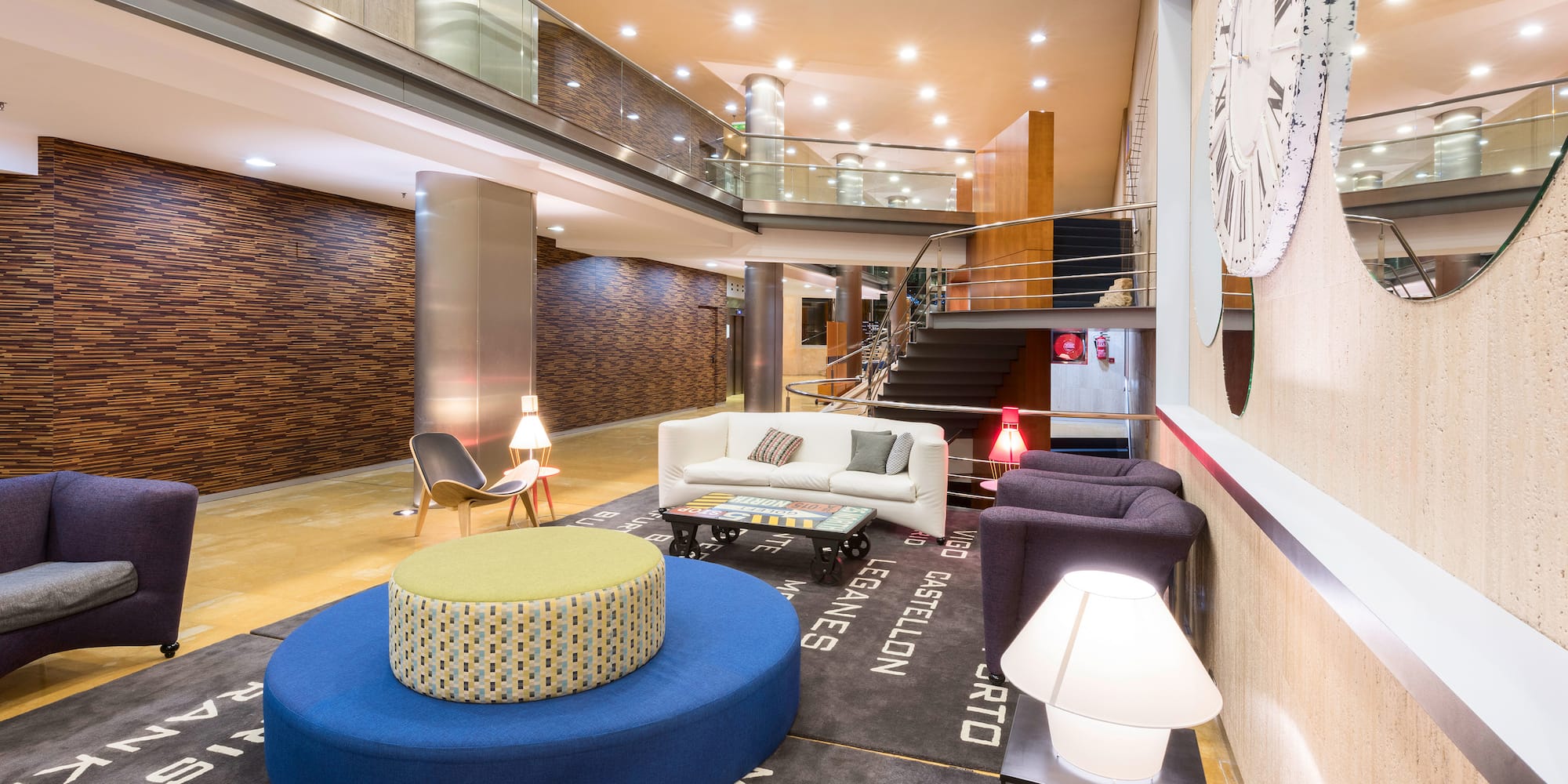 a room with a large round blue ottoman and a white couch