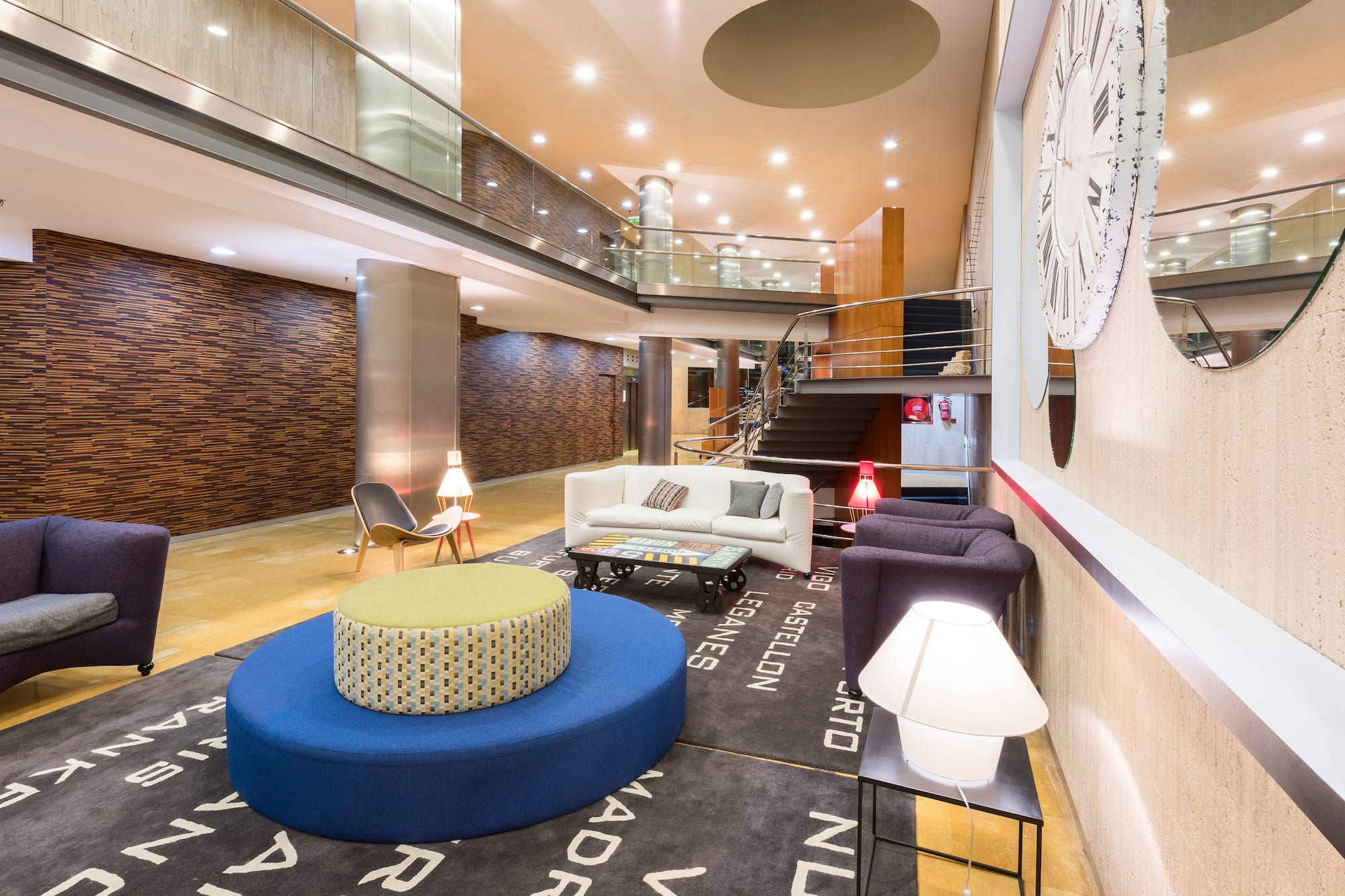 a room with a large round blue ottoman and a white couch