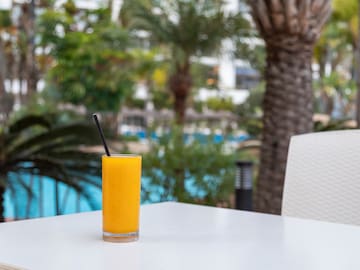 a glass of orange juice on a table