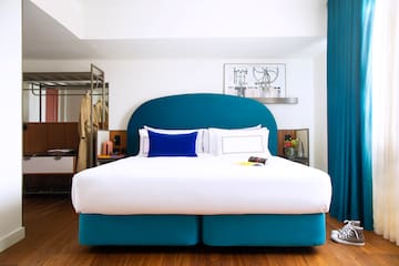 a bed with a blue headboard