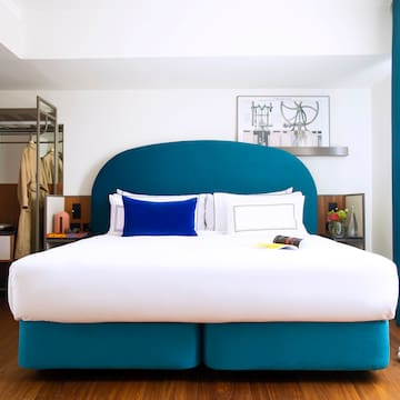 a bed with a blue headboard