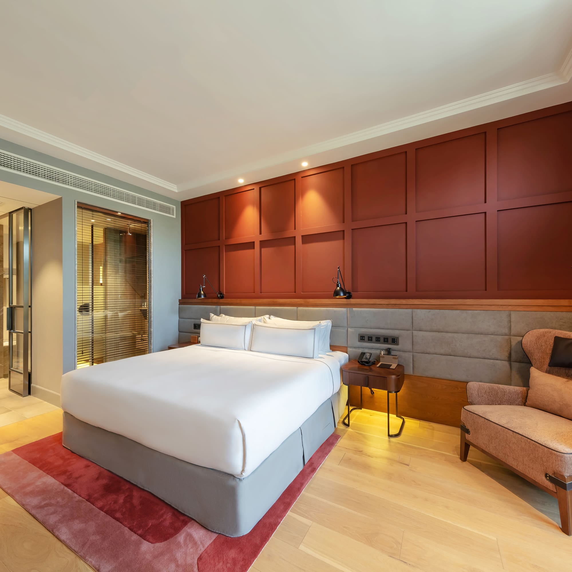 a bedroom with a bed and a chair