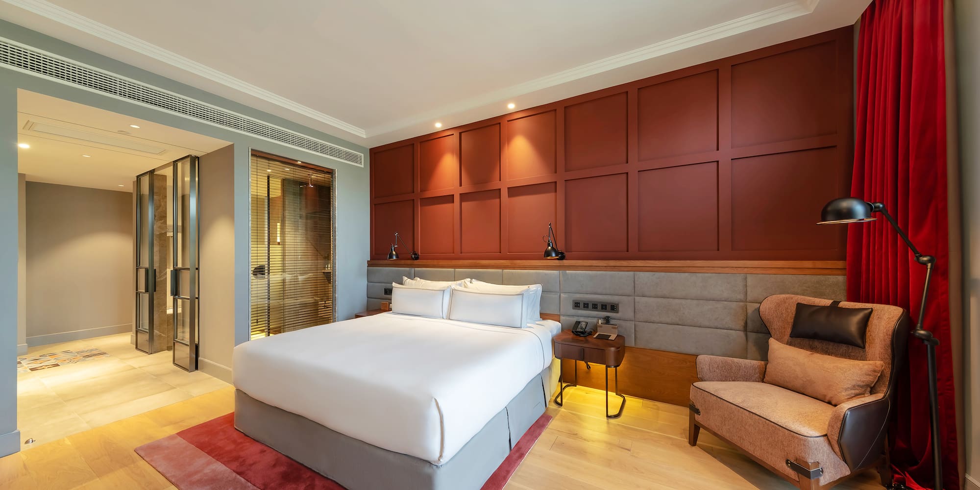 a bedroom with a bed and a chair