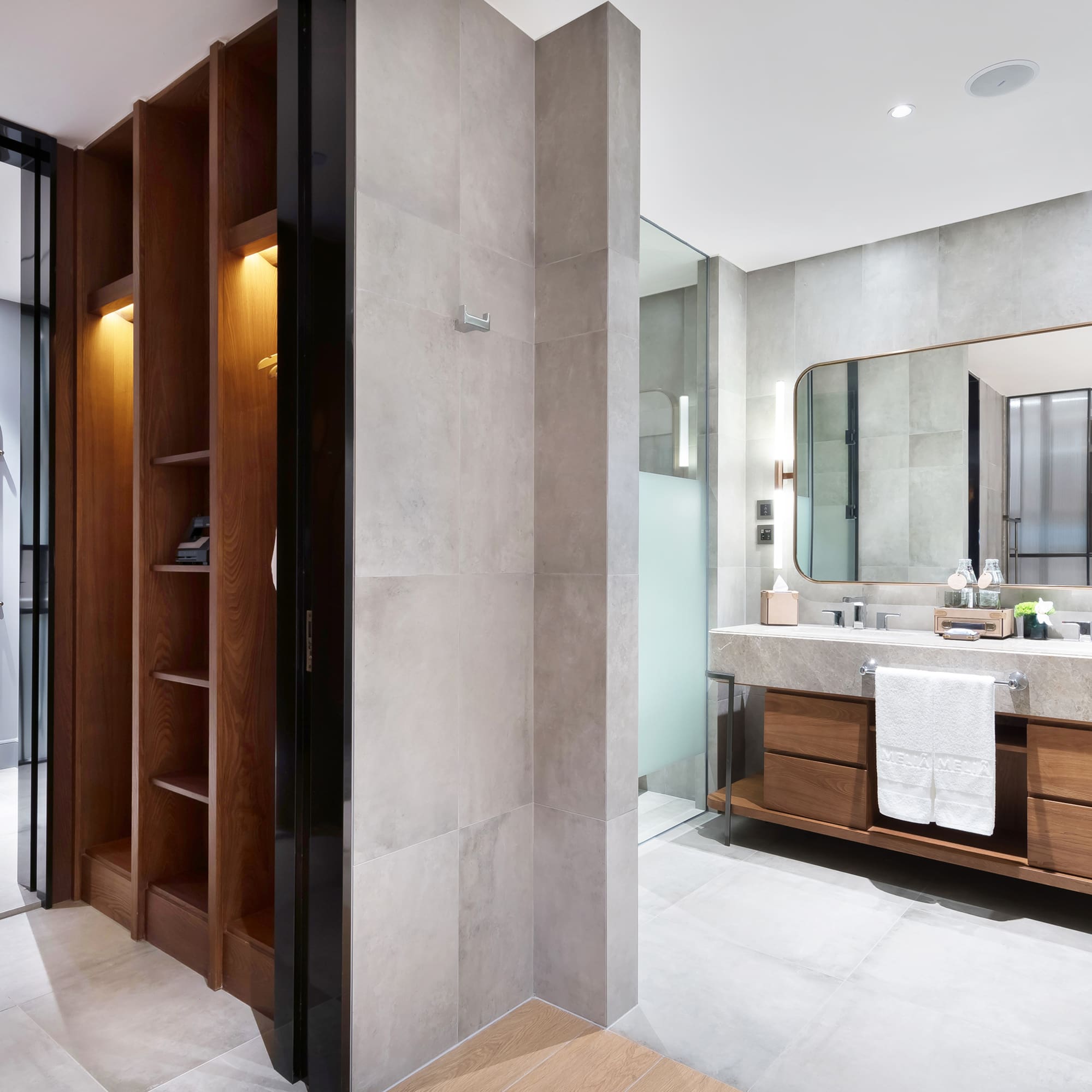a bathroom with a mirror and shelves