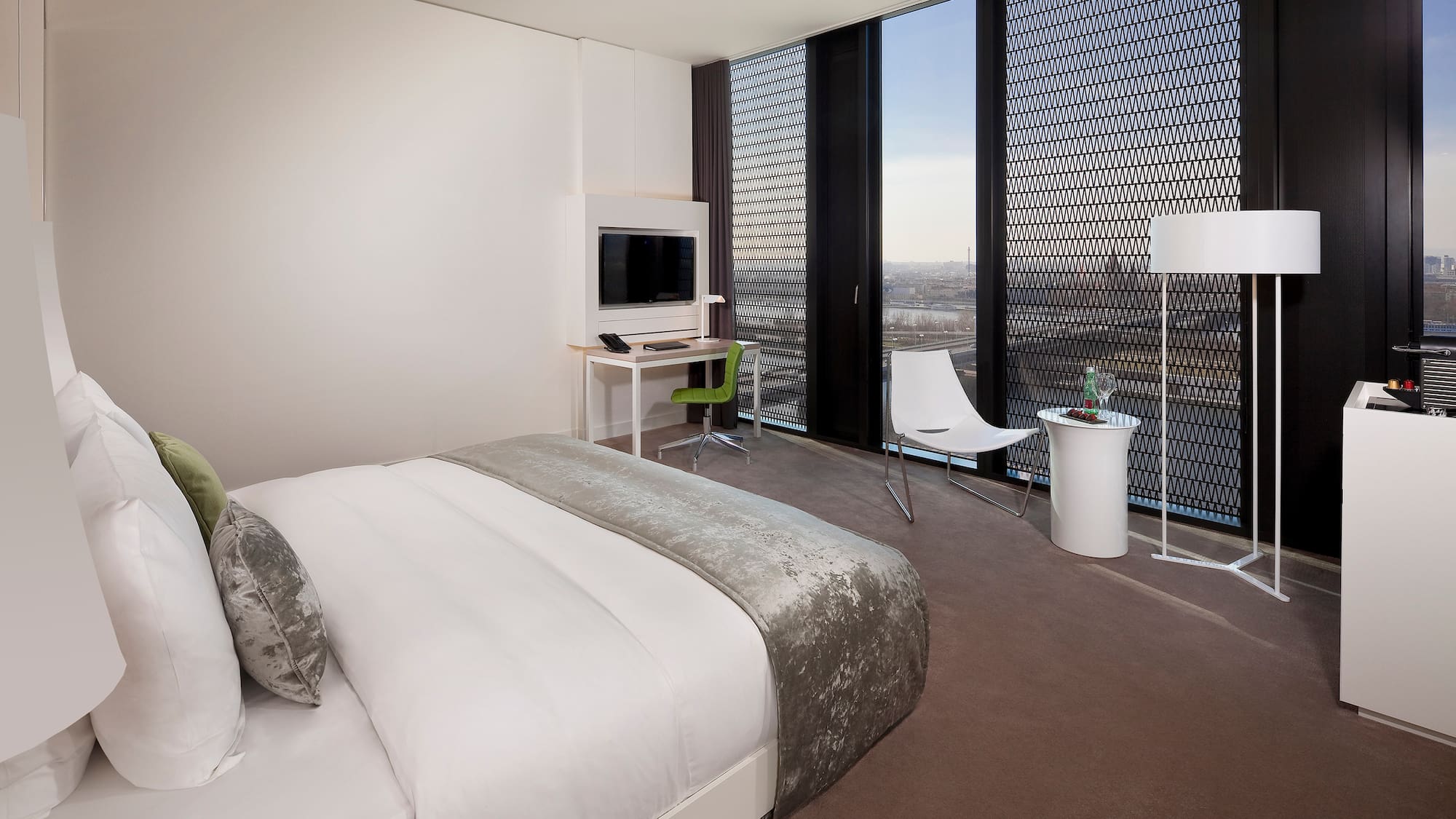 a bedroom with a bed and a desk and chair