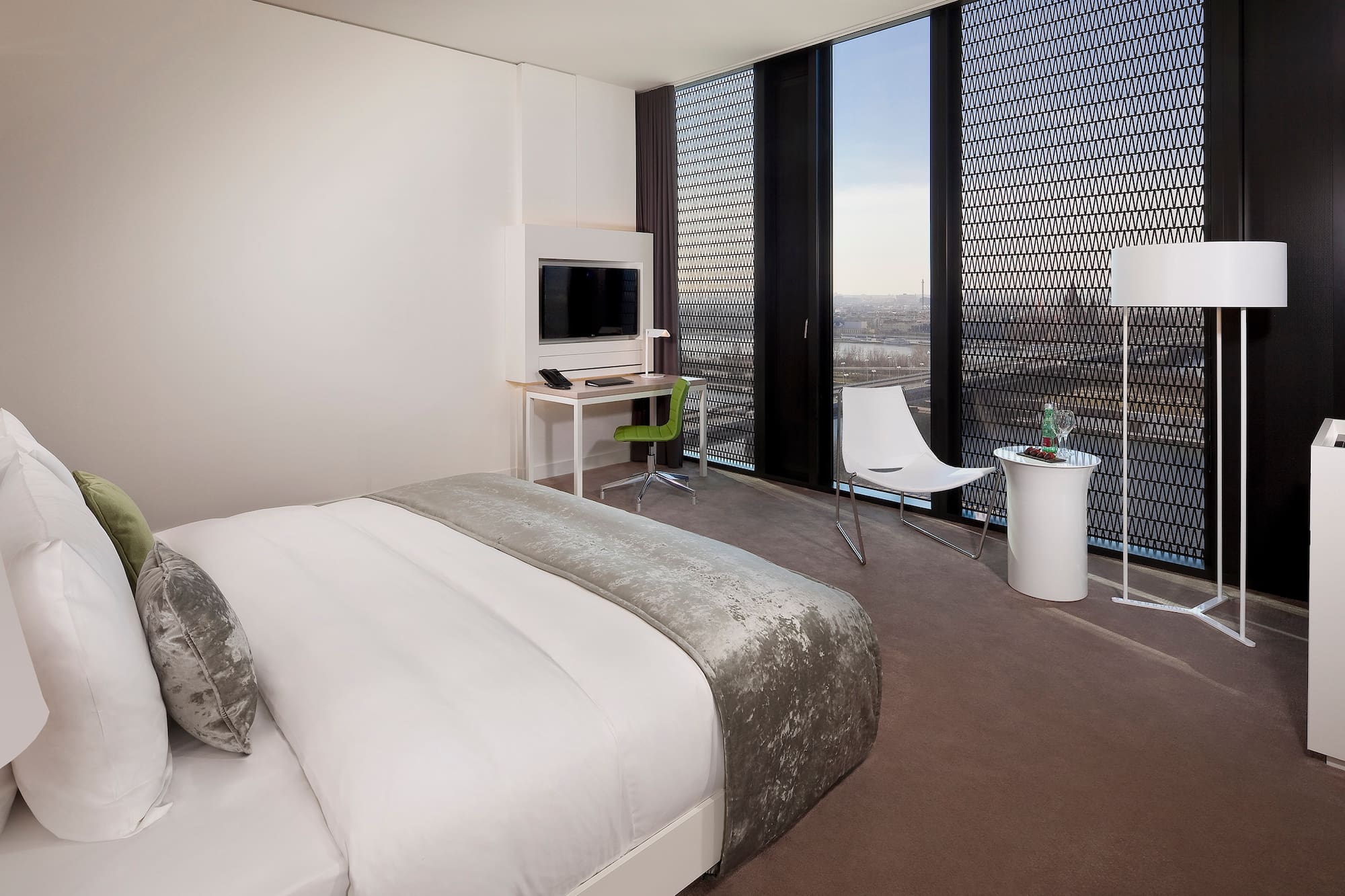 a bedroom with a bed and a desk and chair