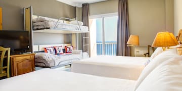 a room with bunk beds and a window