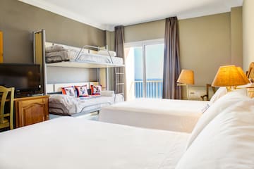 a room with bunk beds and a window
