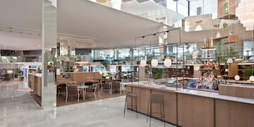 a restaurant with a bar and chairs
