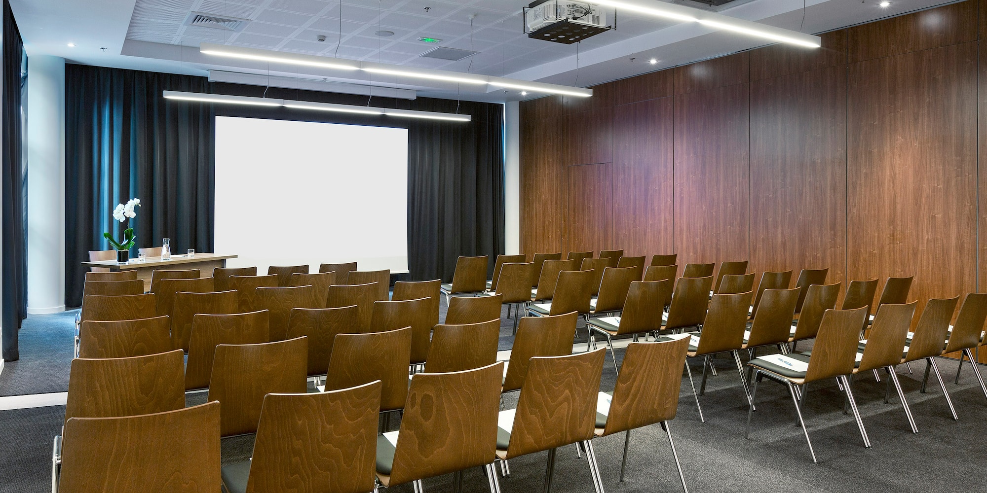 a room with chairs and a projector screen