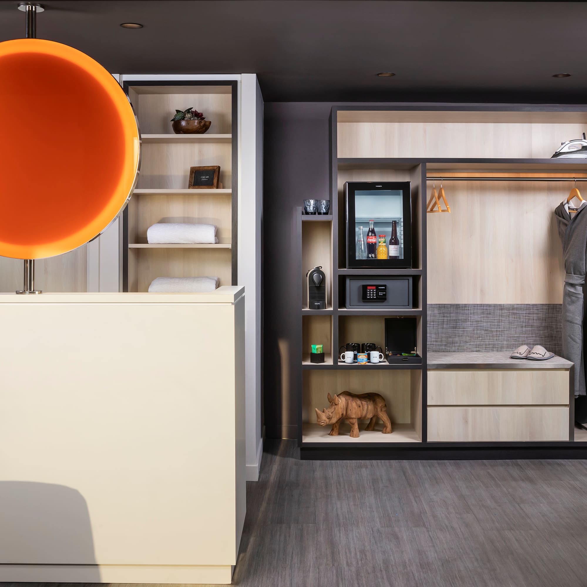 a room with a display of clothes and a toy rhinoceros