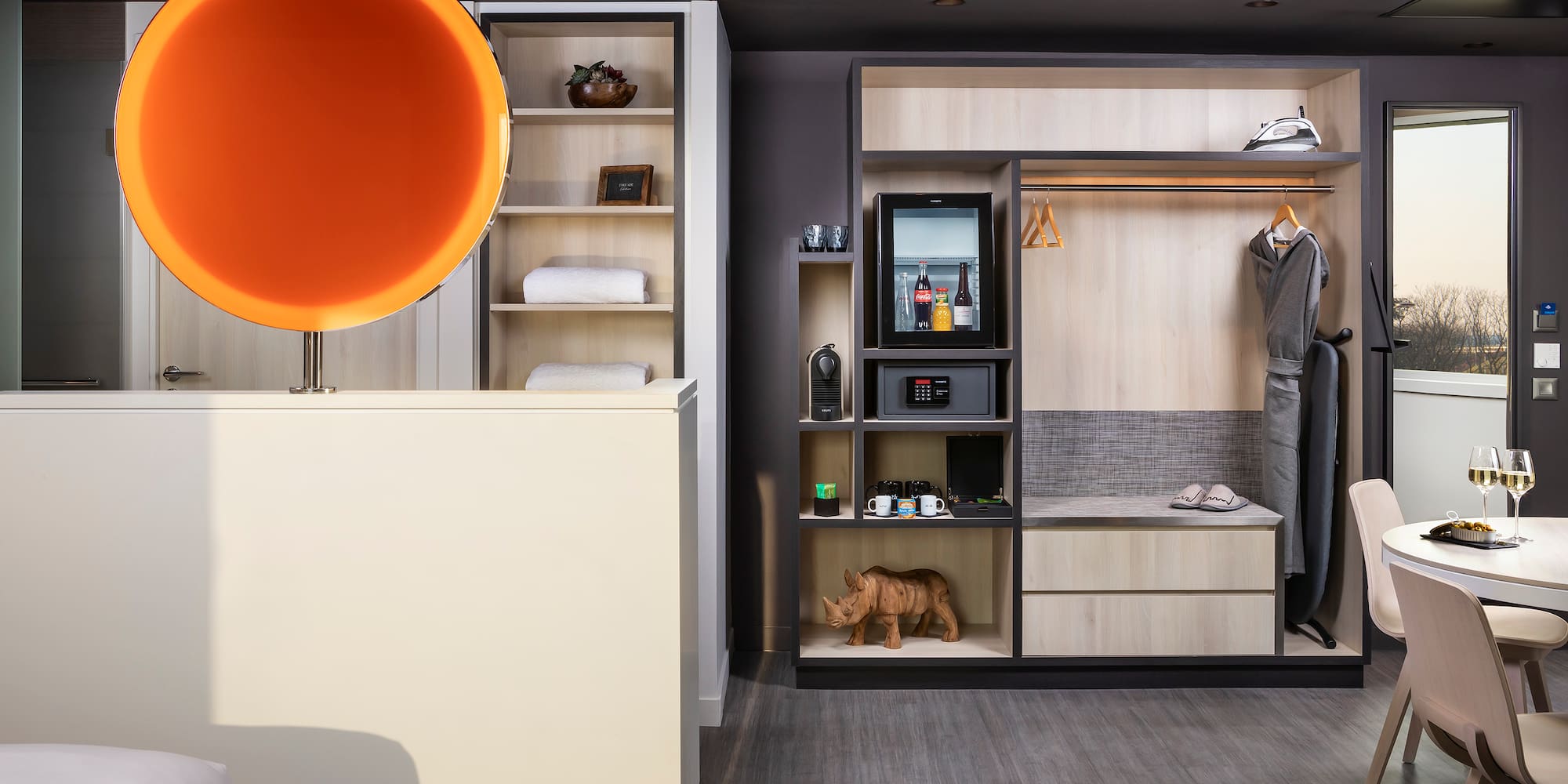 a room with a display of clothes and a toy rhinoceros