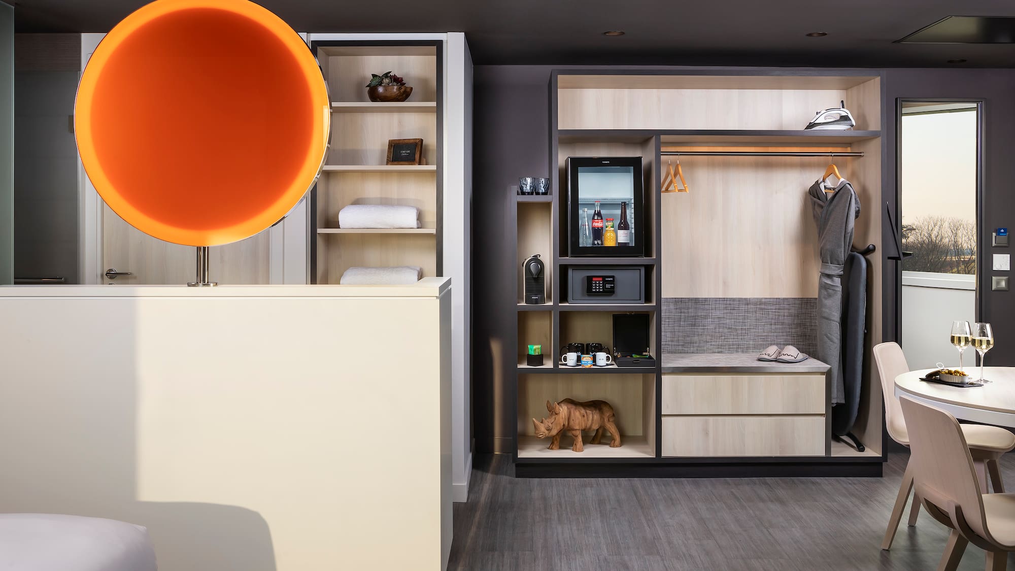 a room with a display of clothes and a toy rhinoceros