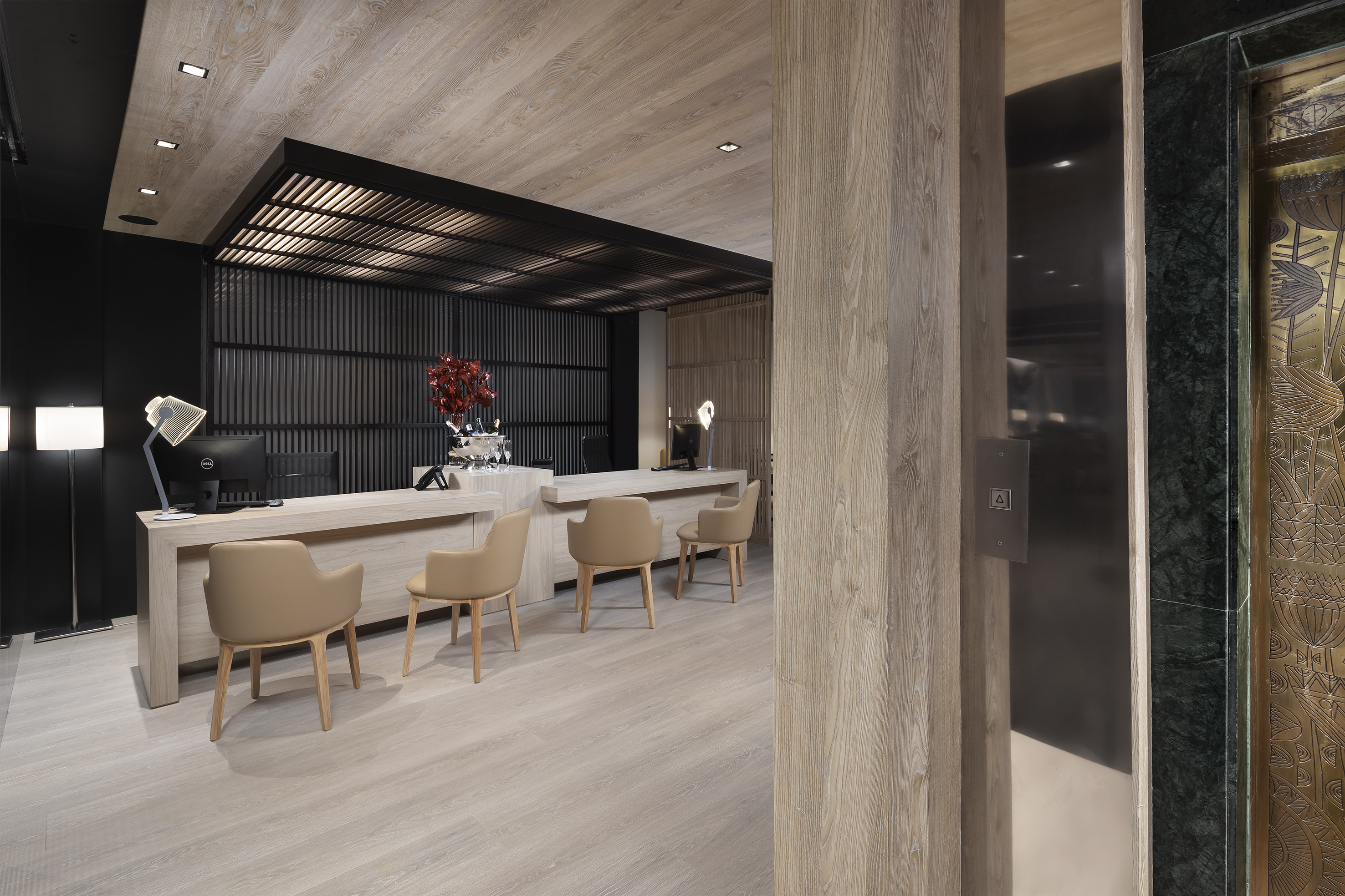 a room with a reception desk and chairs