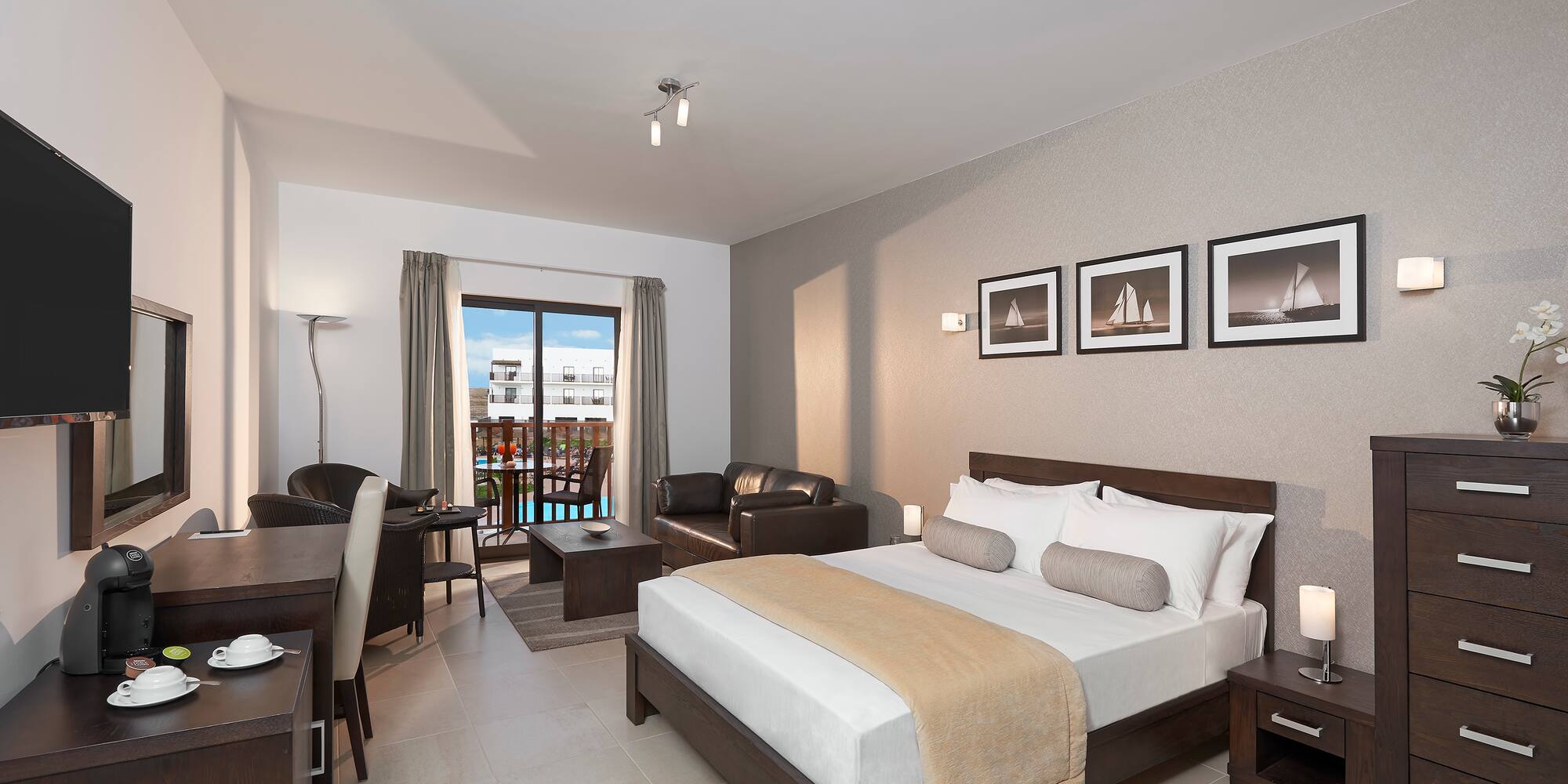 a bedroom with a bed and a table and chairs