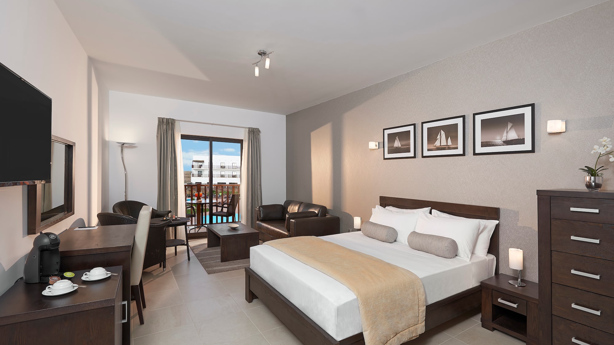 a bedroom with a bed and a table and chairs