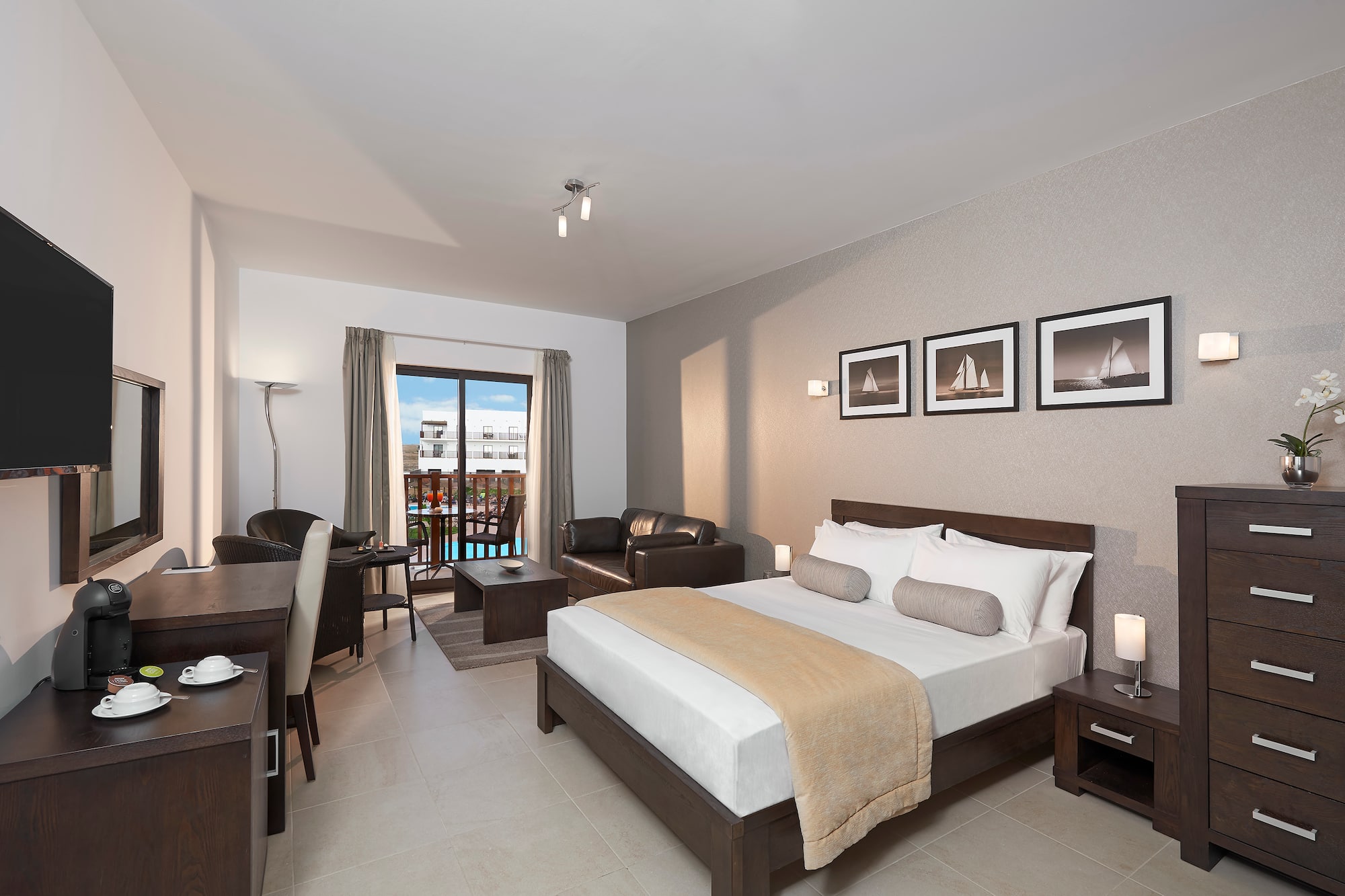 a bedroom with a bed and a table and chairs