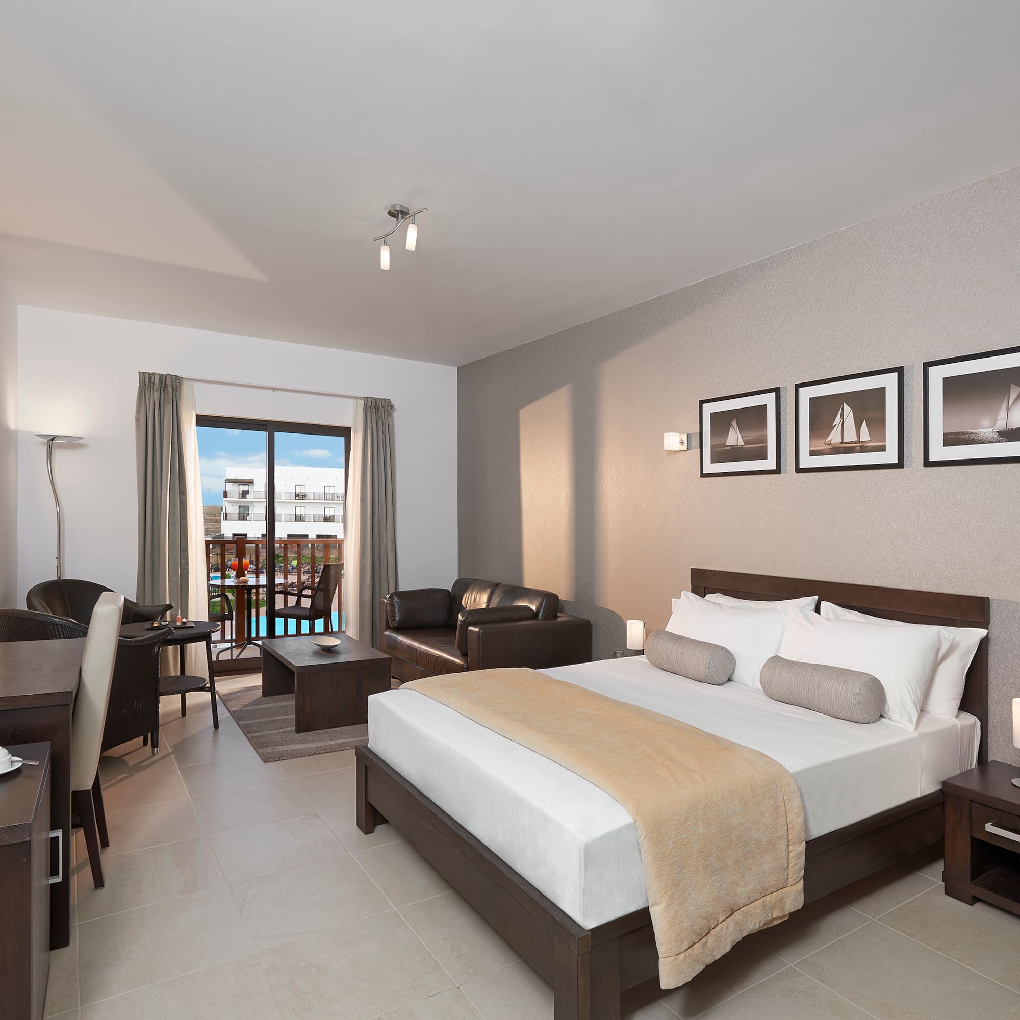 a bedroom with a bed and a table and chairs