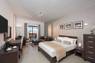 a bedroom with a bed and a table and chairs