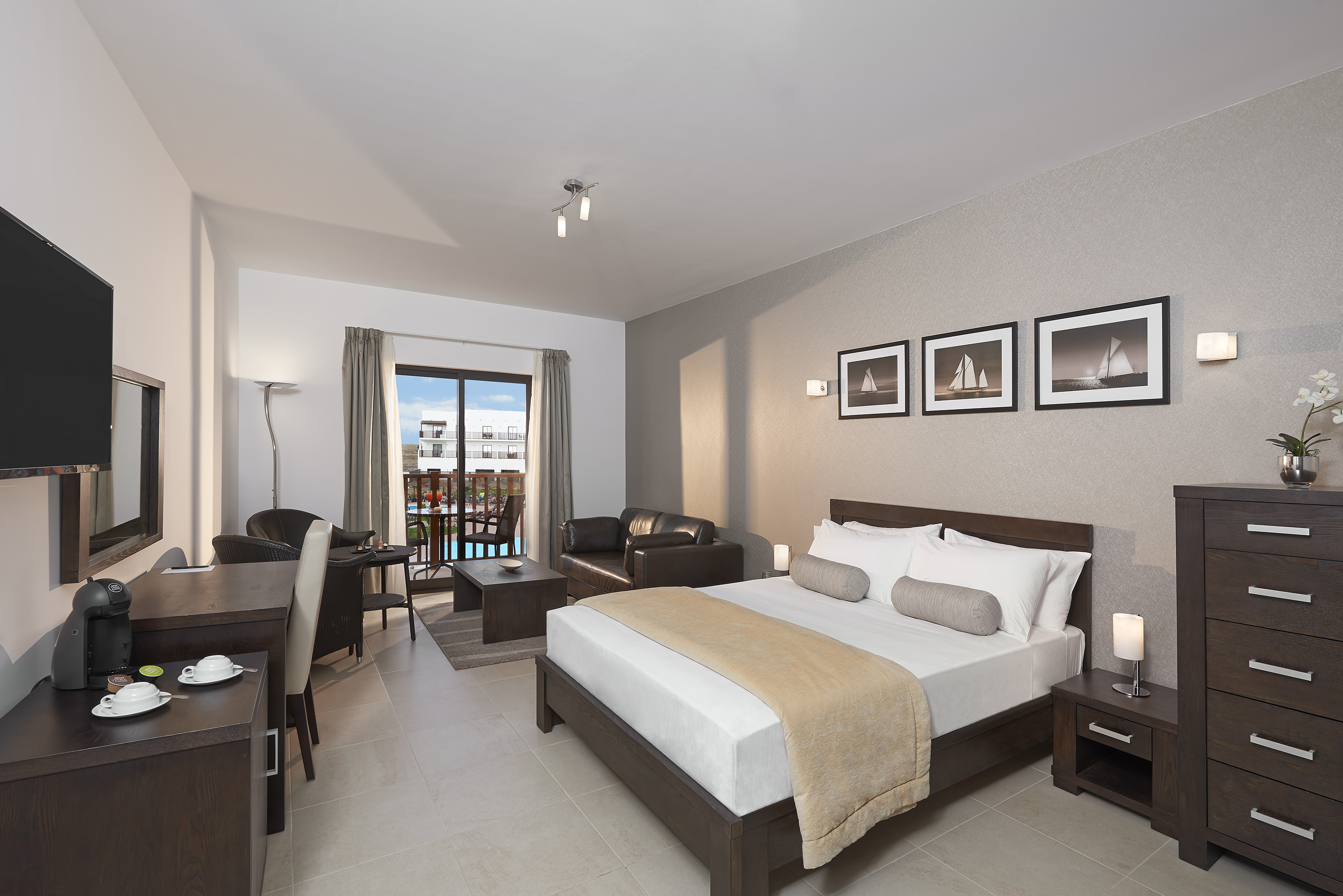 a bedroom with a bed and a table and chairs