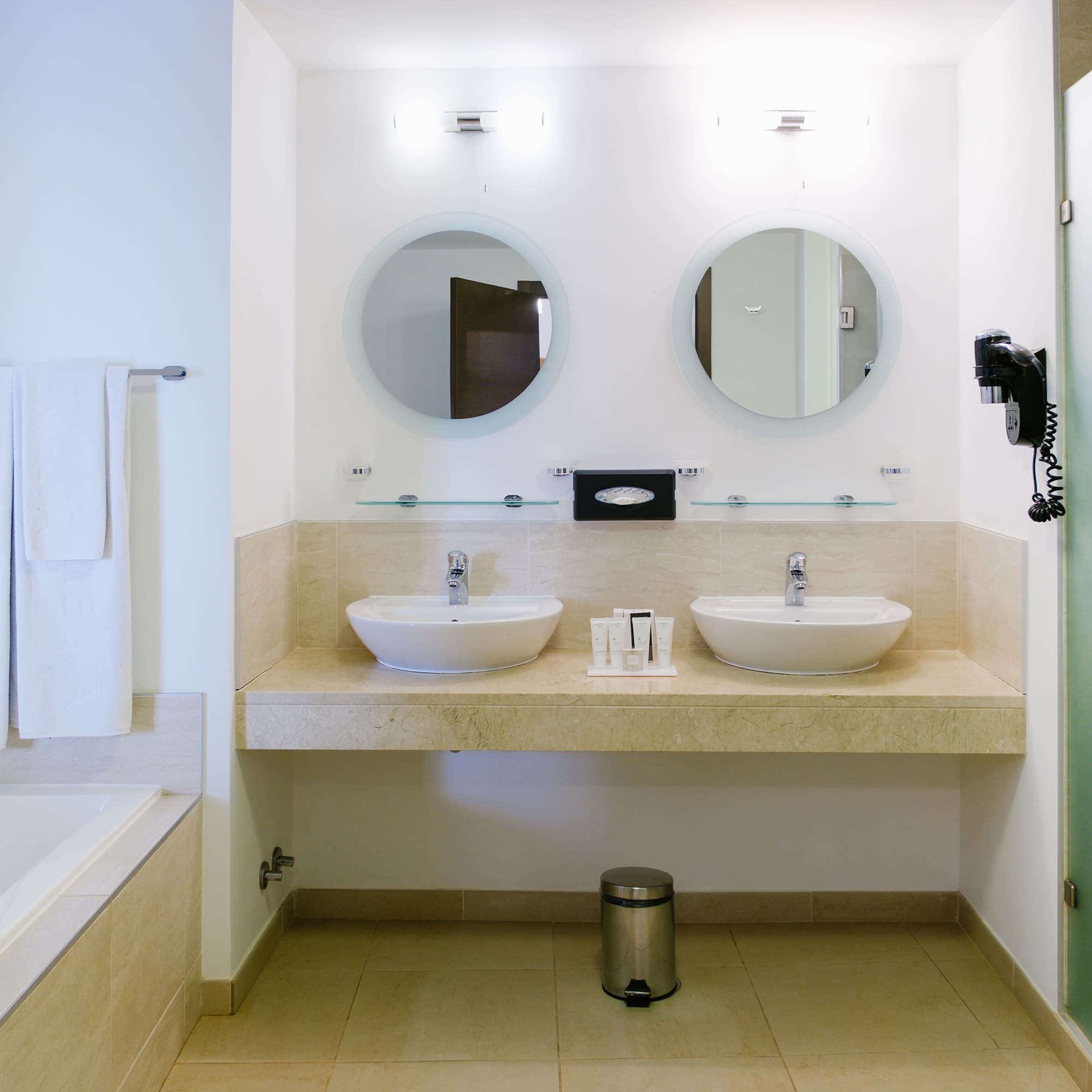 a bathroom with two sinks and a bathtub