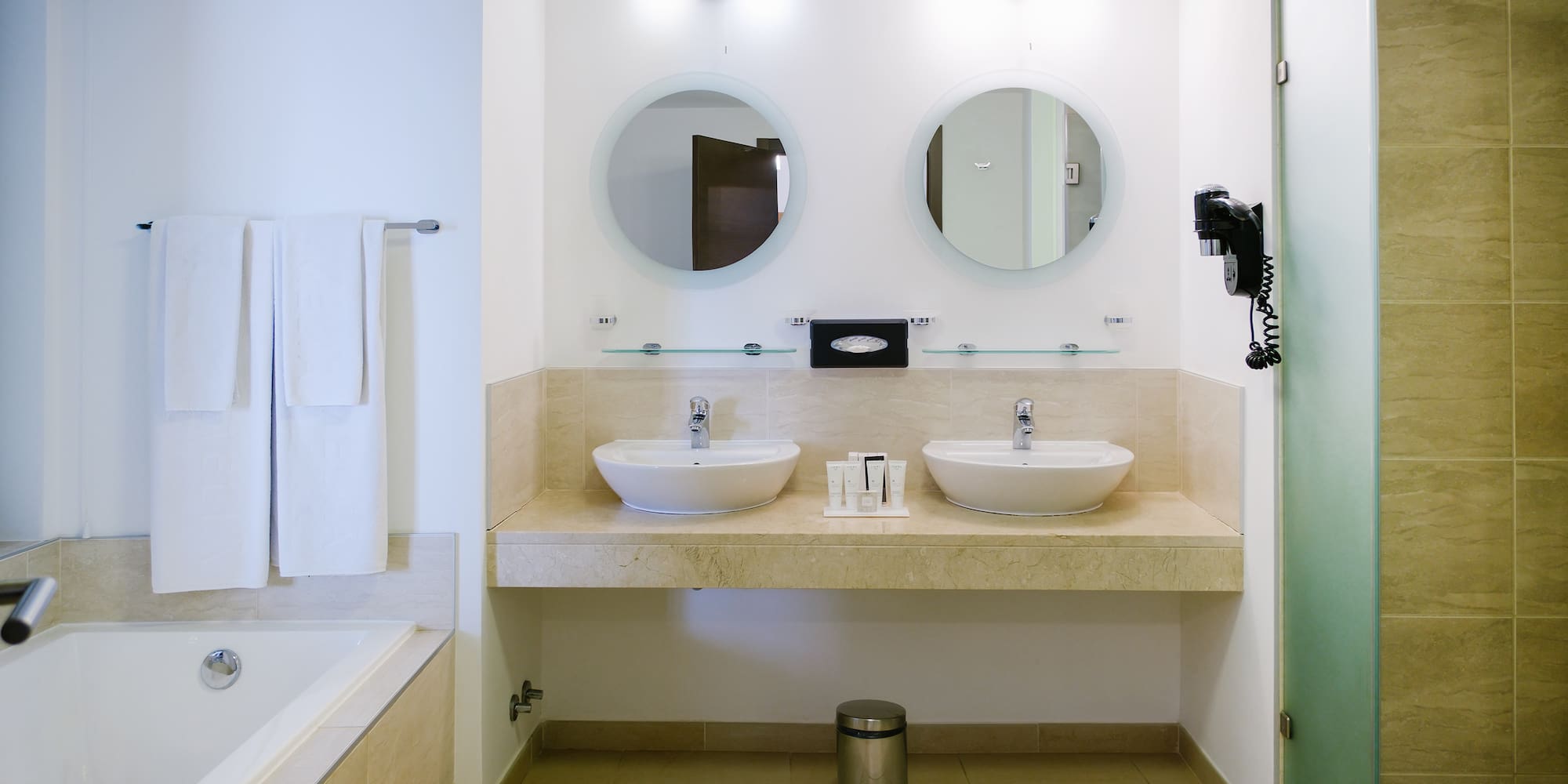 a bathroom with two sinks and a bathtub