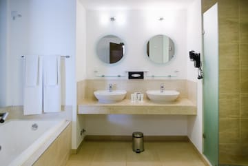 a bathroom with two sinks and a bathtub