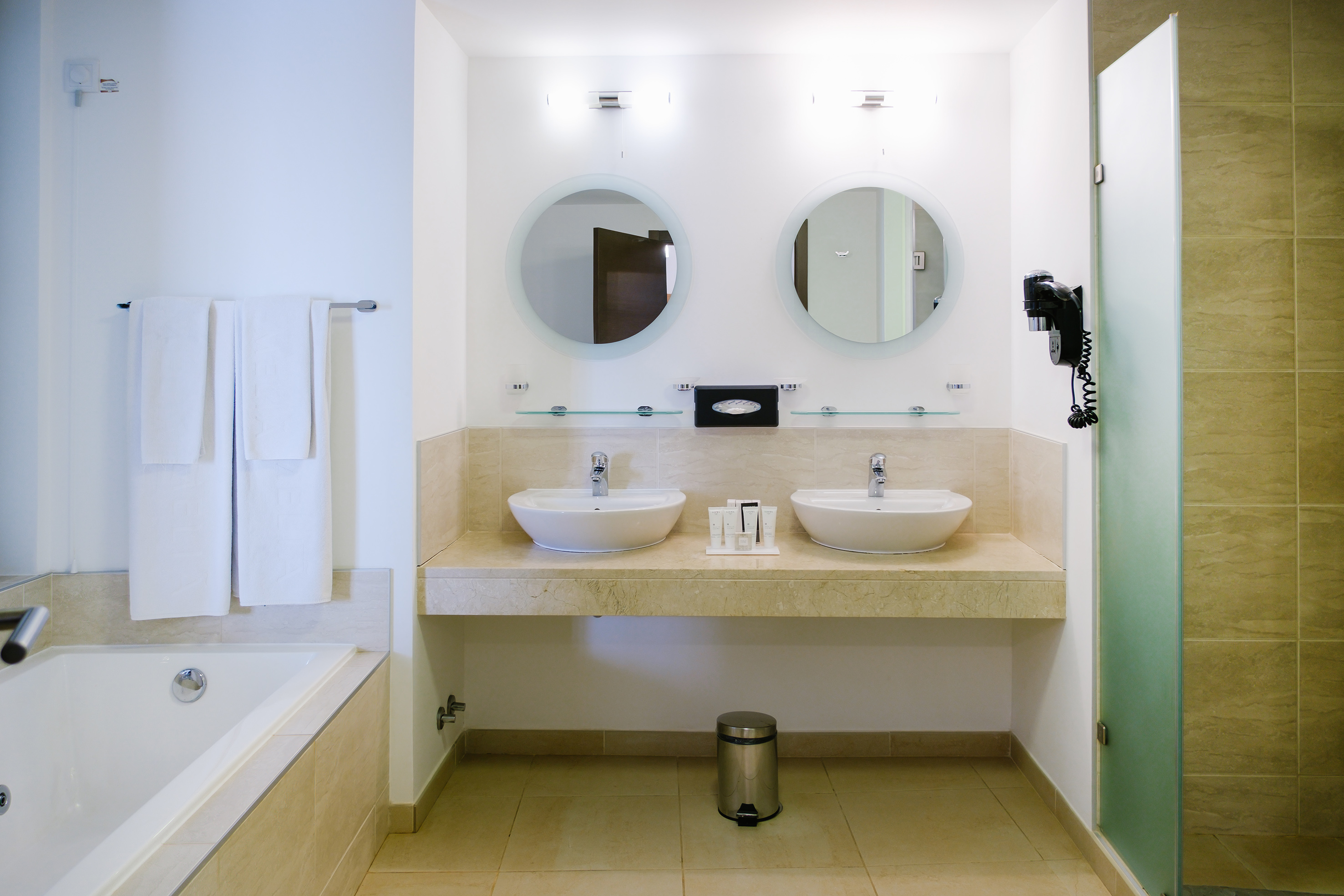 a bathroom with two sinks and a bathtub