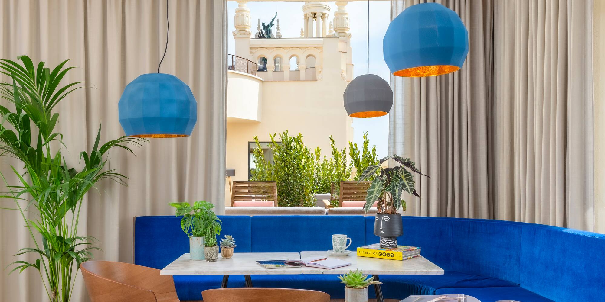 a room with a blue couch and blue chairs