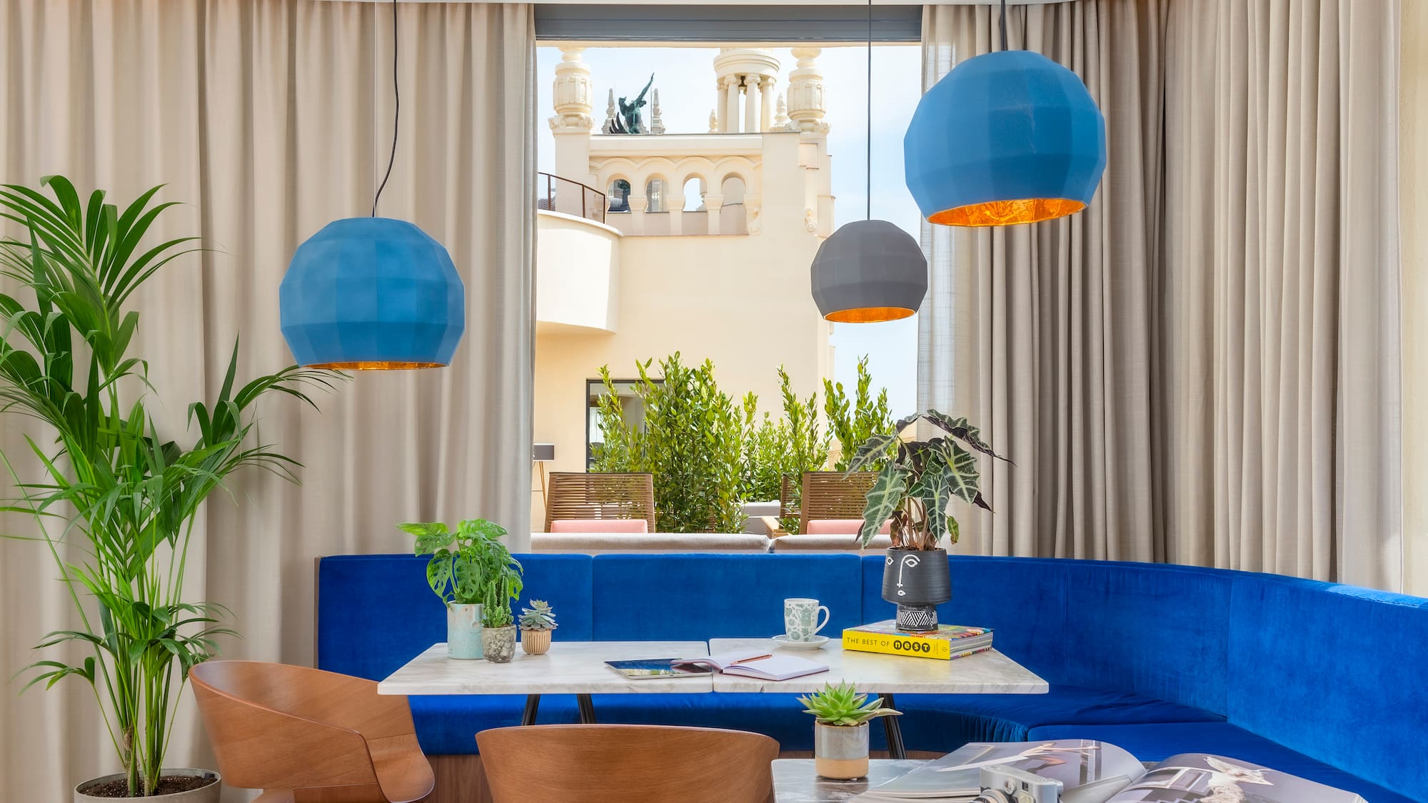 a room with a blue couch and blue chairs