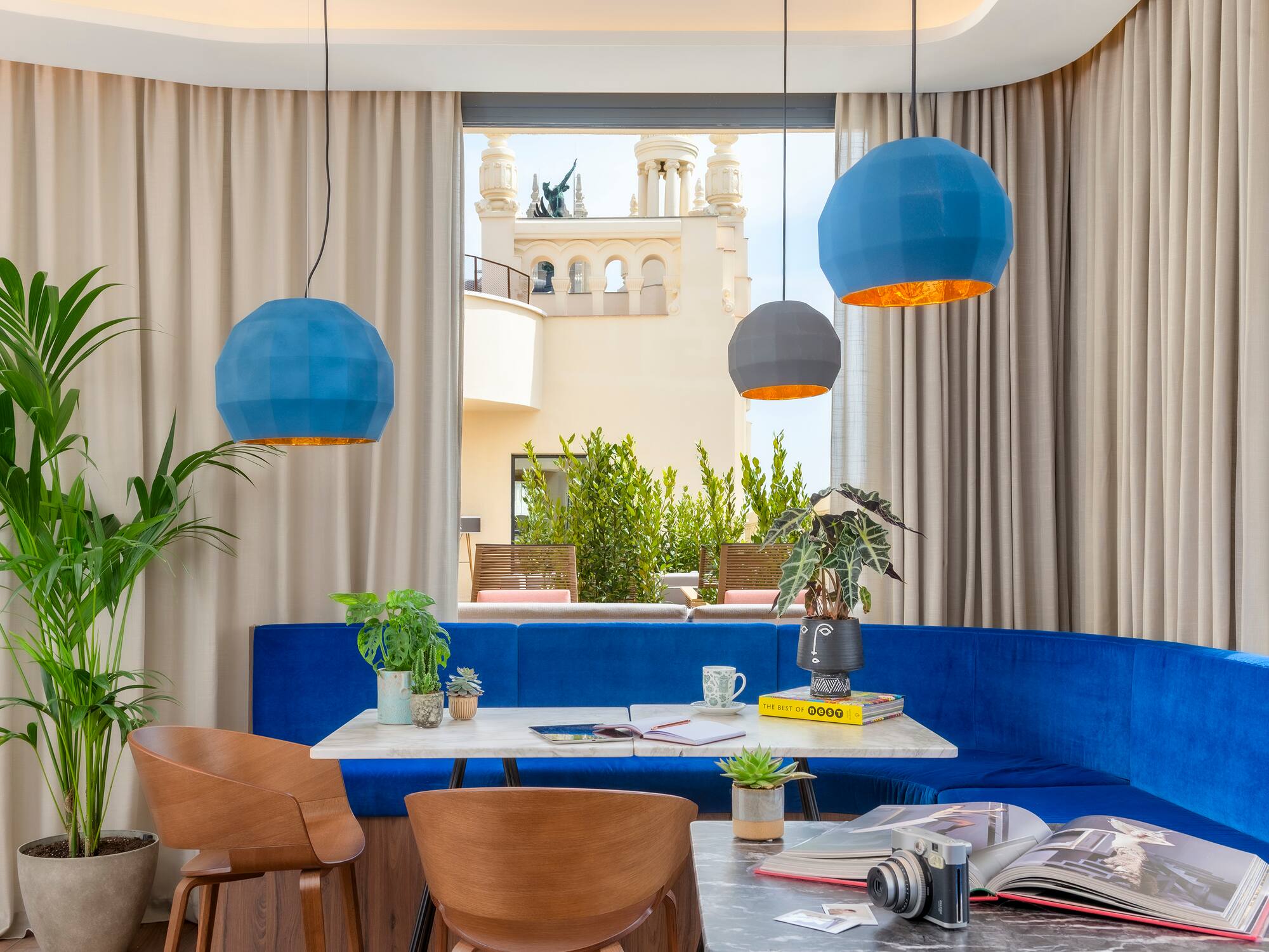 a room with a blue couch and blue chairs
