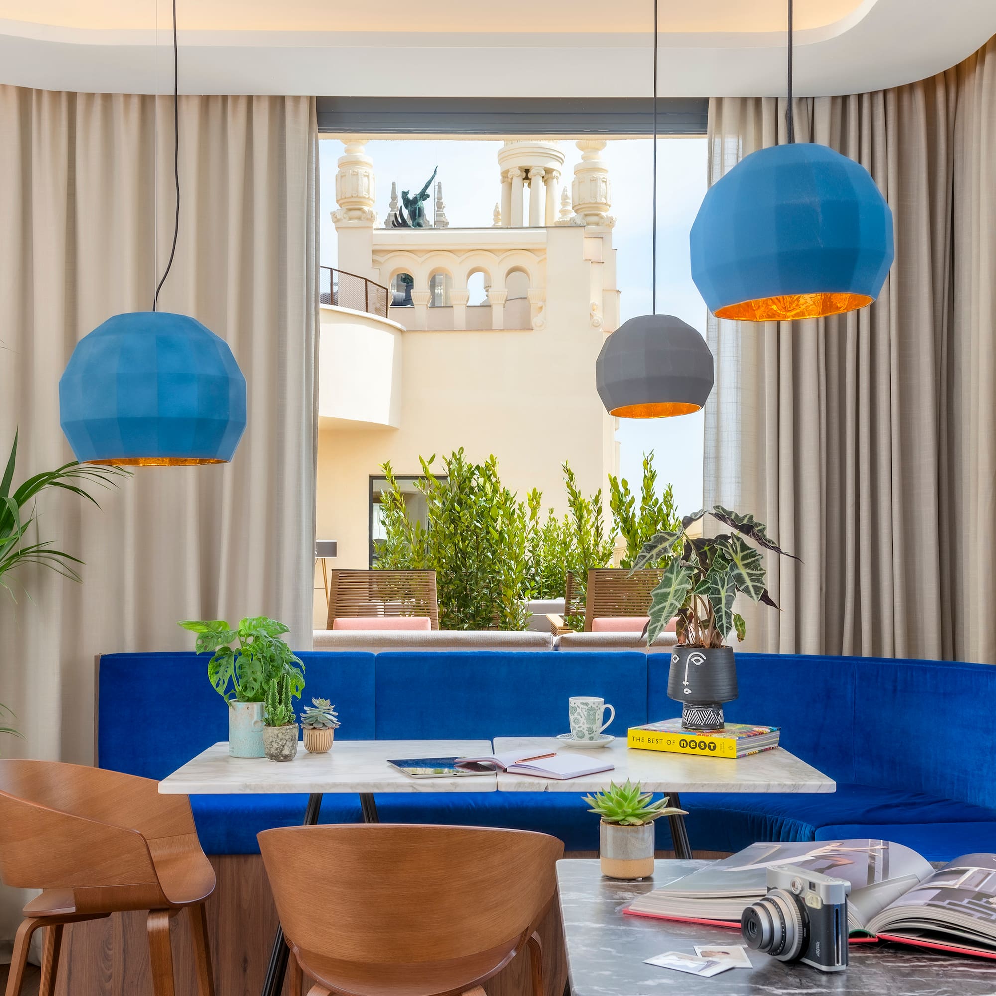 a room with a blue couch and blue chairs
