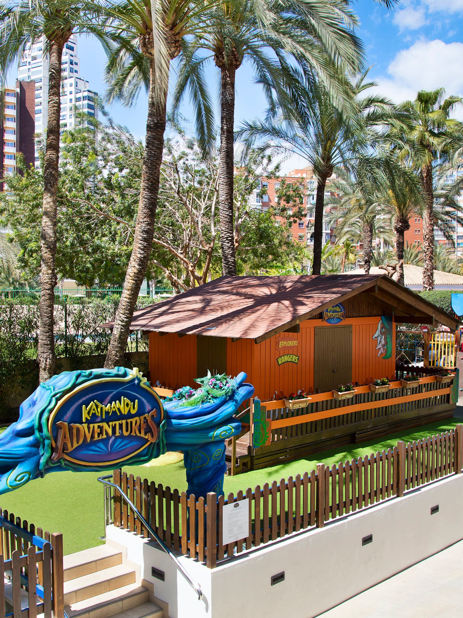 a playground with a blue and yellow sign