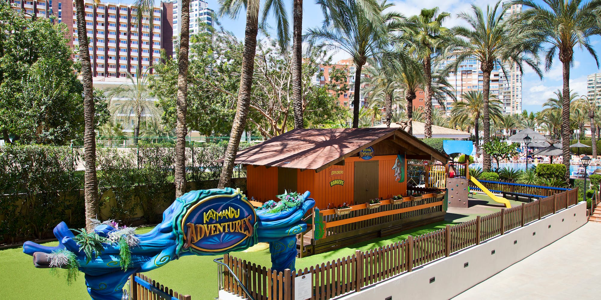 a playground with a blue and yellow sign