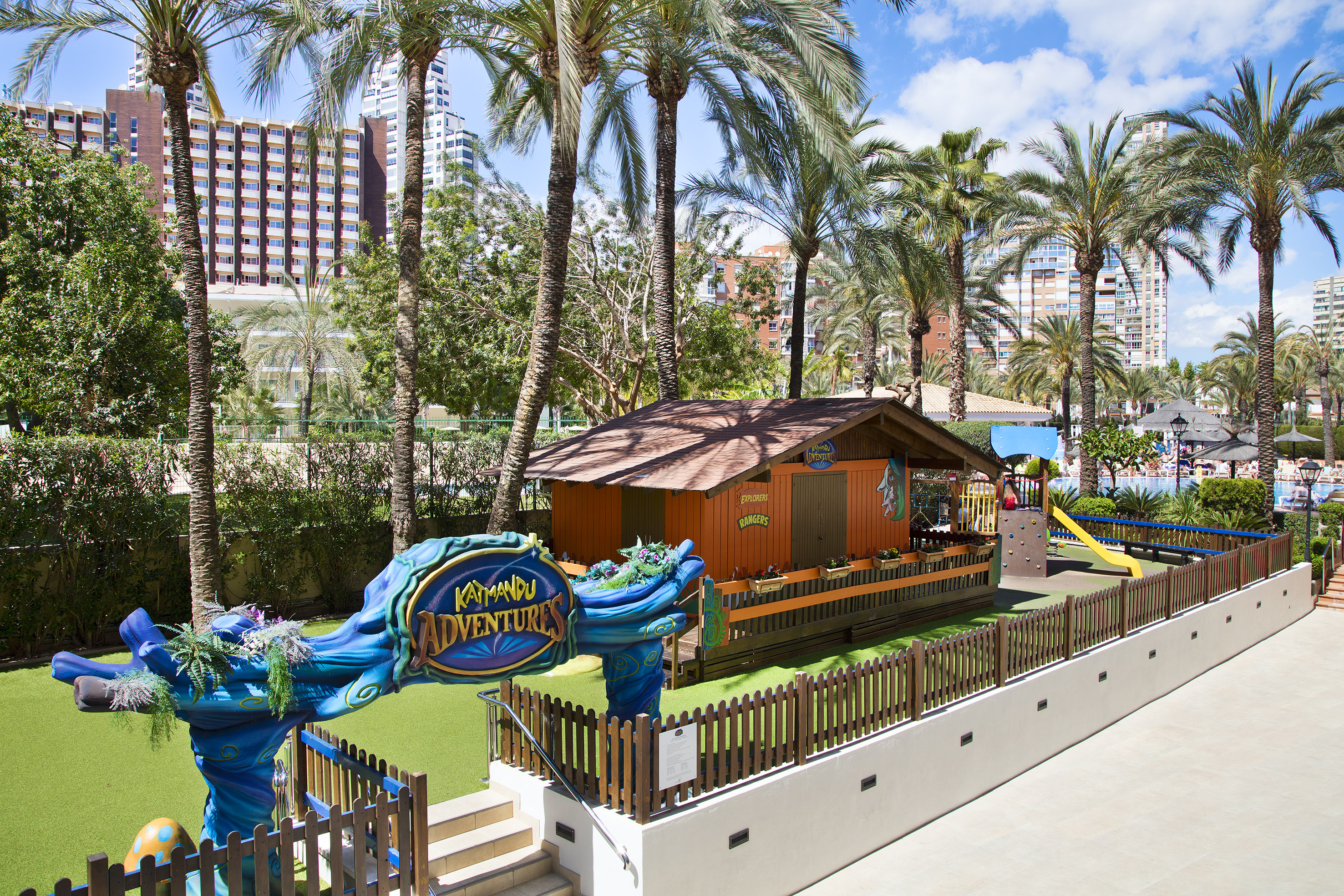 a playground with a blue and yellow sign