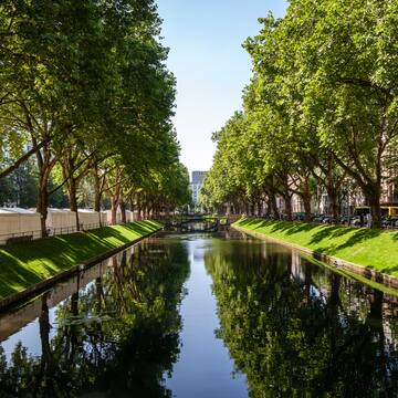a water way with trees and grass