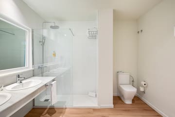 a bathroom with a glass shower and sink