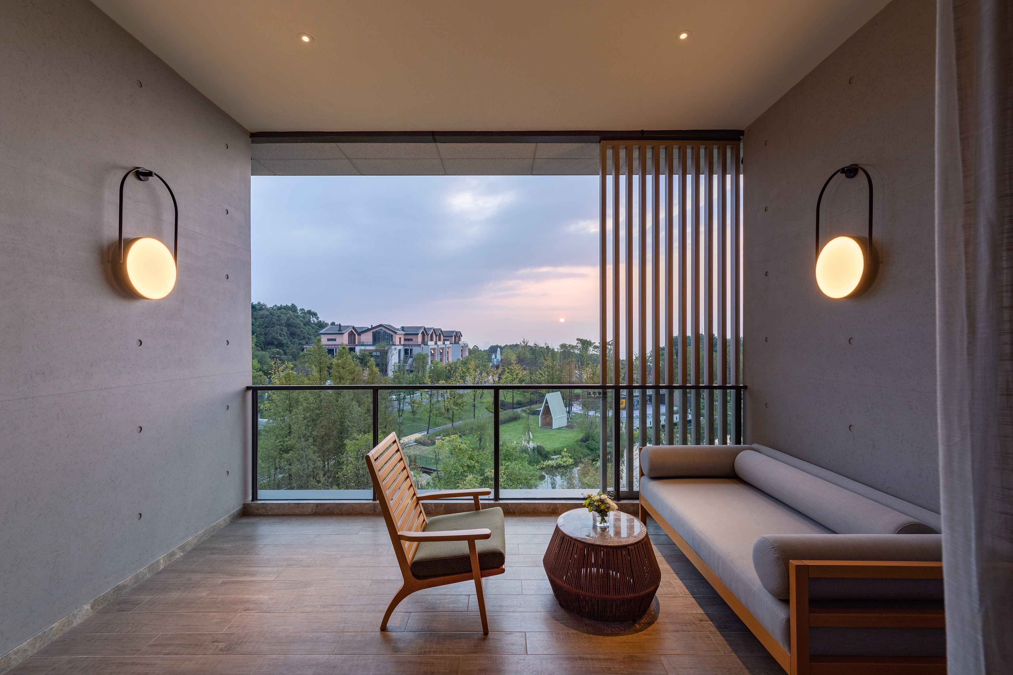 Modern balcony design with lounge area and sunset view.