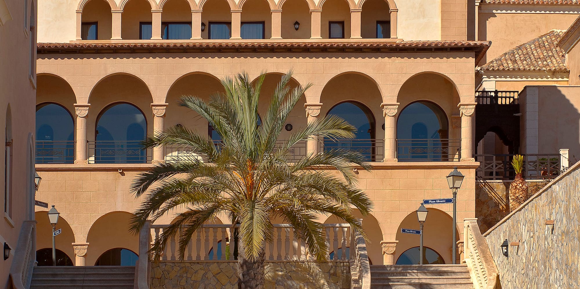 a building with palm trees and a clock tower
