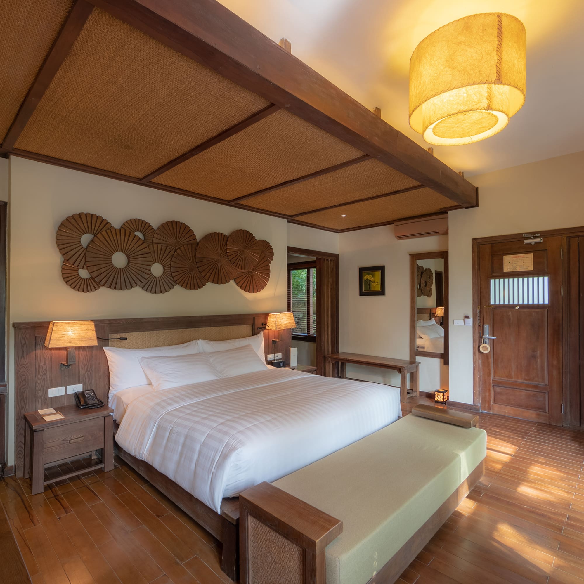 a bedroom with a bed and a lamp